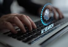 AI Search Optimization – How Websites Can Stay Visible When Users Stop Clicking Hands typing on a laptop with an AI search optimization graphic on screen