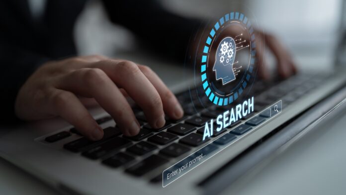 AI Search Optimization - How Websites Can Keep Visibility as Clicks Decline Hands typing on a laptop with an AI search optimization graphic on screen