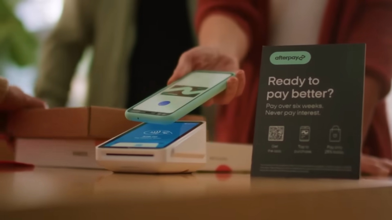 A shopper uses Afterpay at a store payment terminal