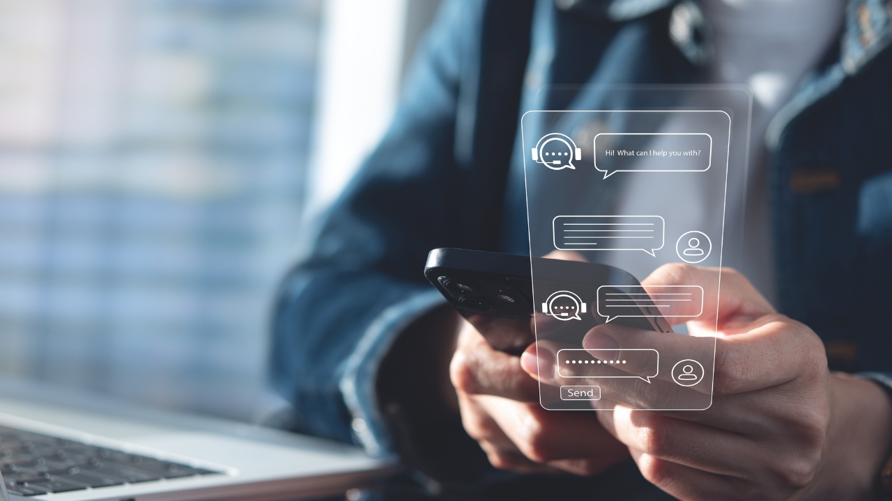 A person holds a phone with AI chatbot messages on the screen