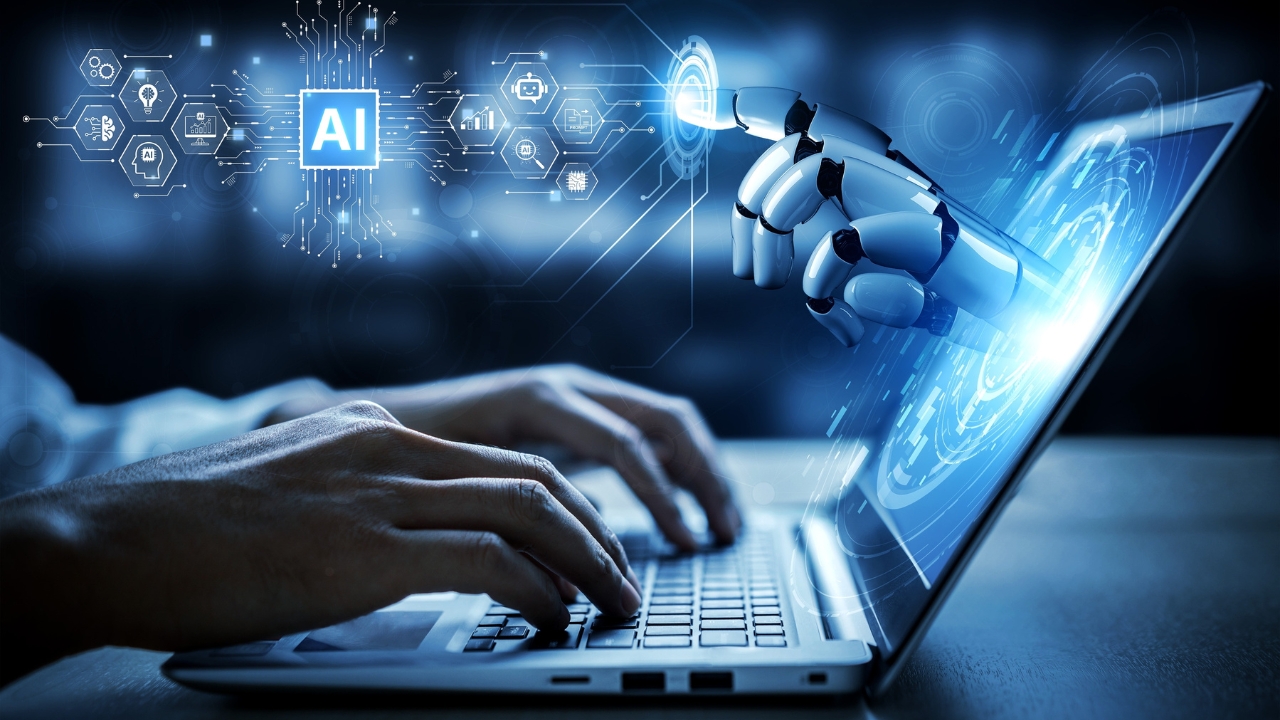 A robot hand points at an AI screen beside a laptop keyboard