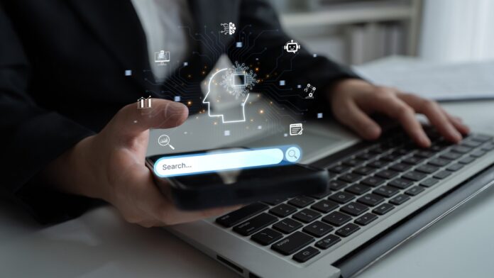 Person using a phone and laptop with an AI-powered search interface on screen