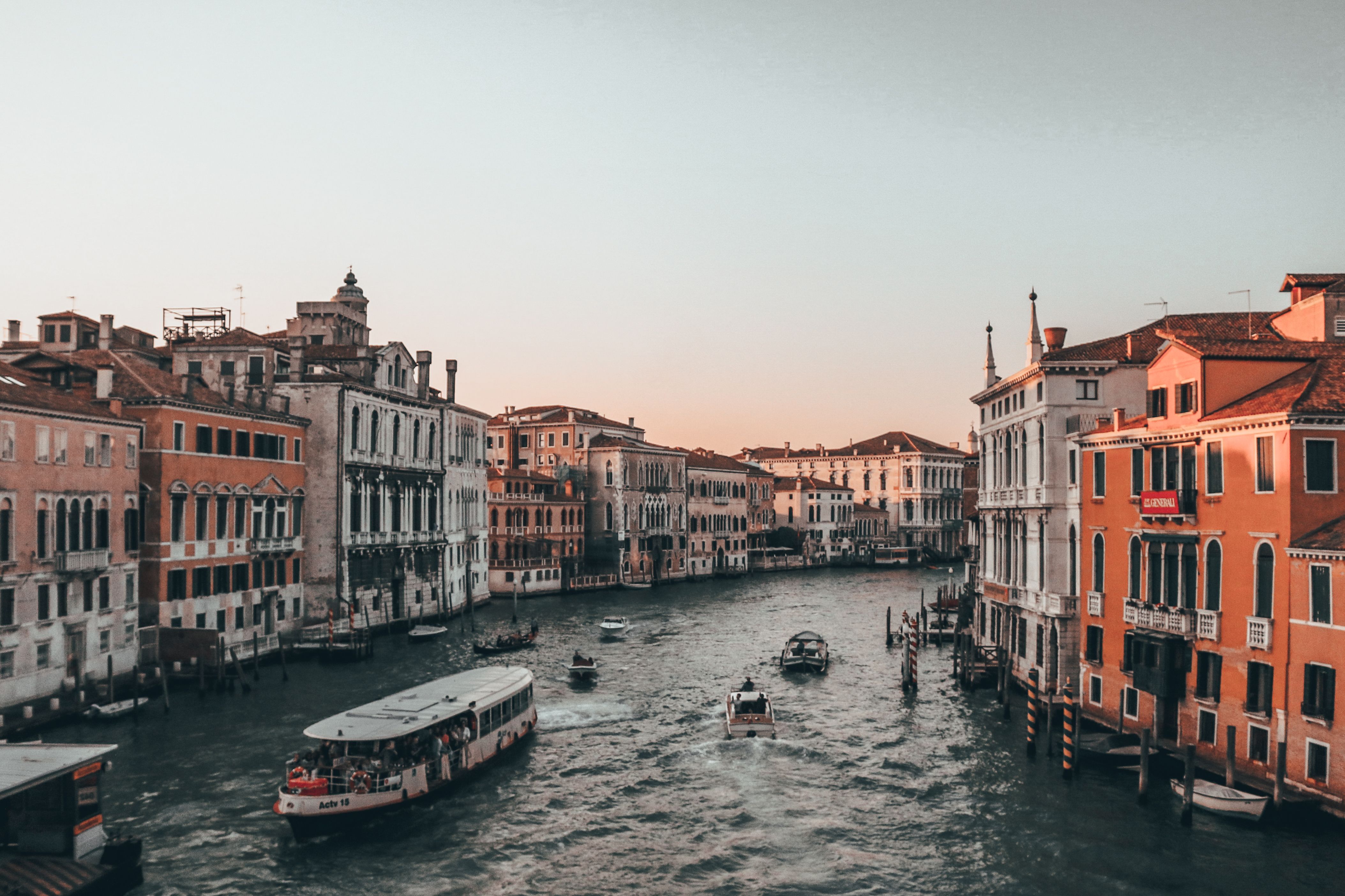 Venice canal at sunset with historic architecture and boats